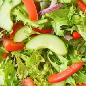 Salad greens with apples, red bell peppers, and red onions